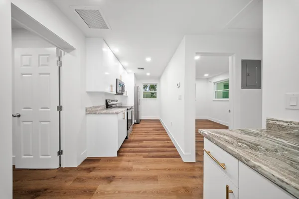 a kitchen with granite countertop a sink and a stove top oven