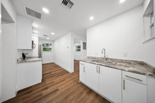 a kitchen with a refrigerator and a stove top oven
