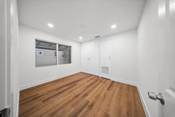 a bathroom with a granite countertop sink a toilet and a mirror