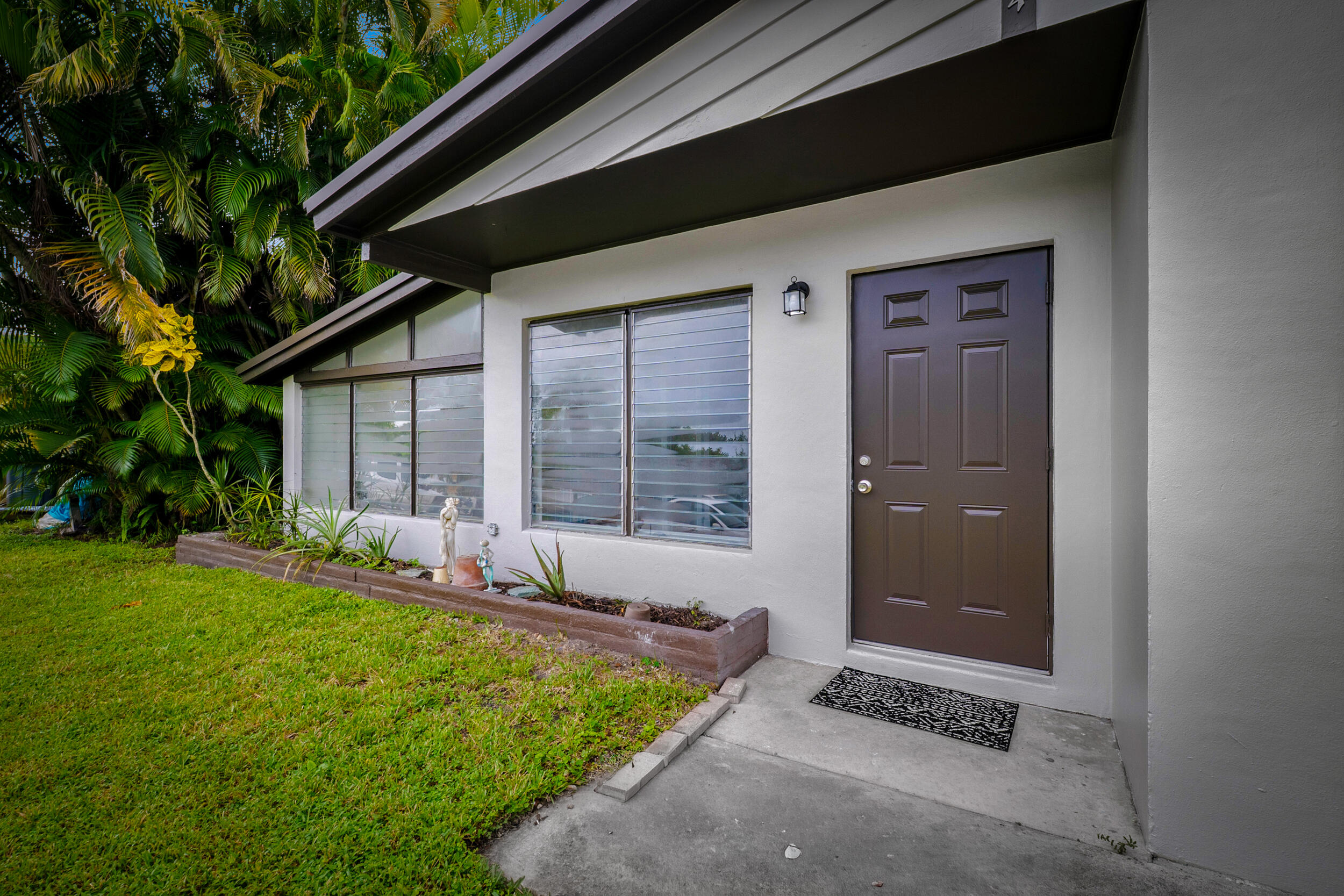 2904 Southeast Bamboo Street Stuart, FL 34997 - Photo 5 of 51 a front view of a house with yard
