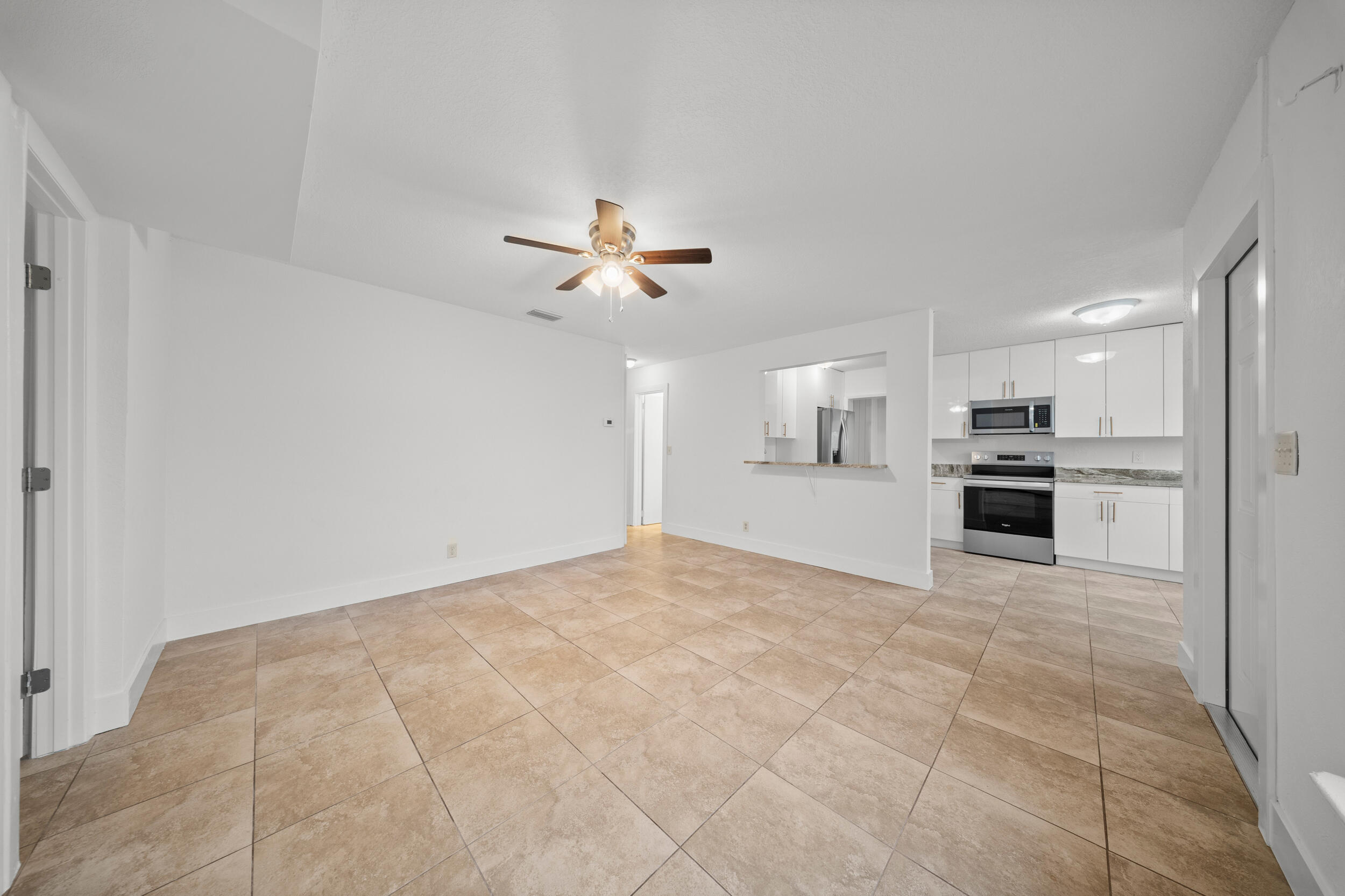 2904 Southeast Bamboo Street Stuart, FL 34997 - Photo 9 of 51 a view of a kitchen with an entryway and a kitchen