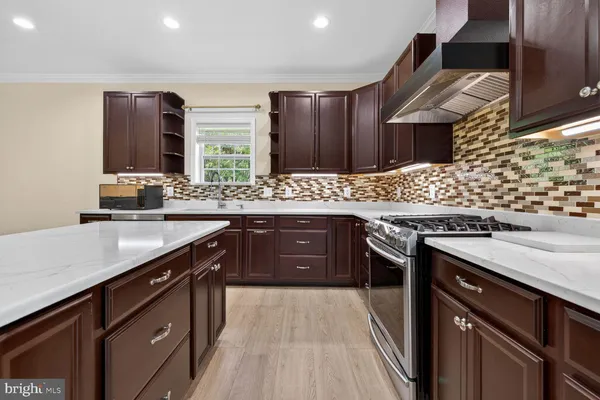 a kitchen with stainless steel appliances granite countertop wooden cabinets and sink