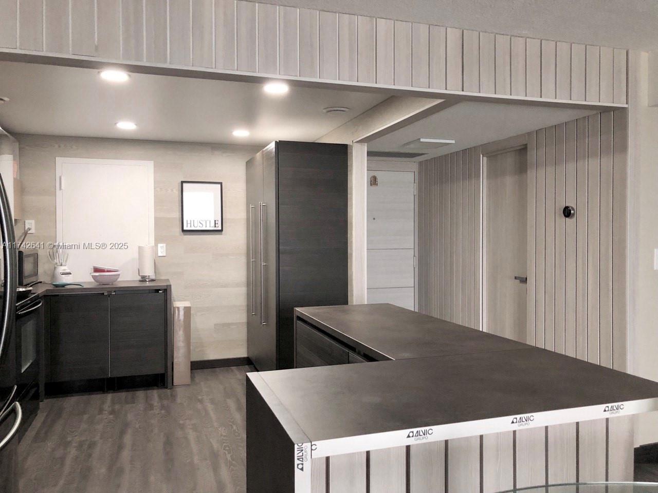 a kitchen with stainless steel appliances granite countertop a refrigerator a sink dishwasher and a stove