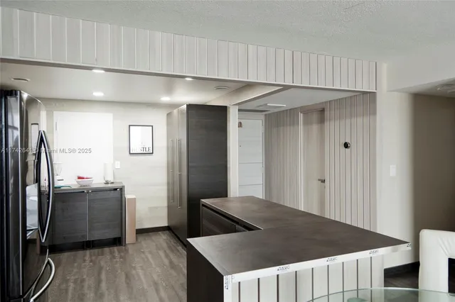 a kitchen with stainless steel appliances a refrigerator and a counter top space