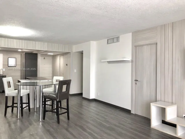 a kitchen with a sink a refrigerator and cabinets