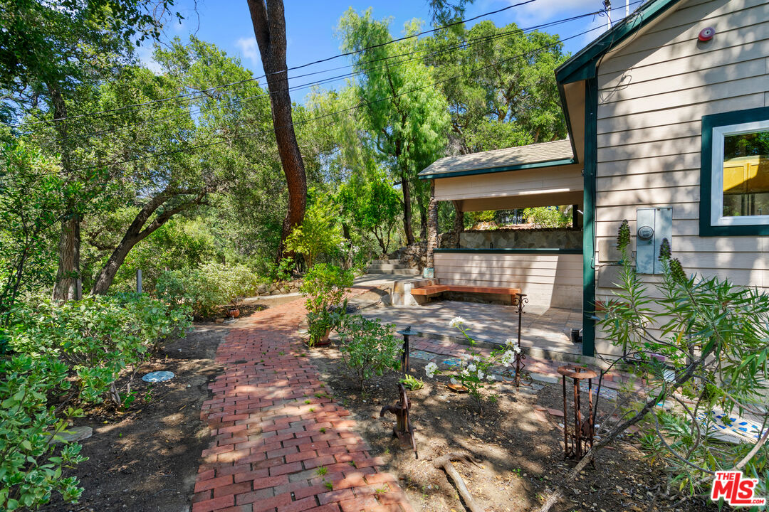 20912 Fontaine Road Topanga, CA 90290 - Photo 42 of 52 a backyard of a house with yard and outdoor seating