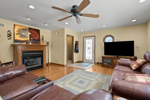 a living room with furniture a flat screen tv and a fireplace