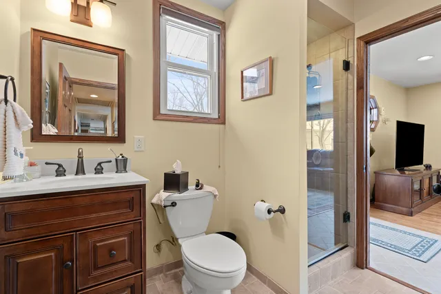 a bathroom with a toilet a sink and mirror