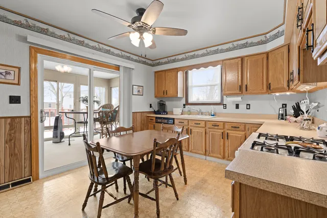 a kitchen with a table chairs stove and refrigerator