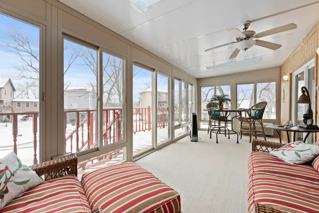 a bedroom with furniture and large windows