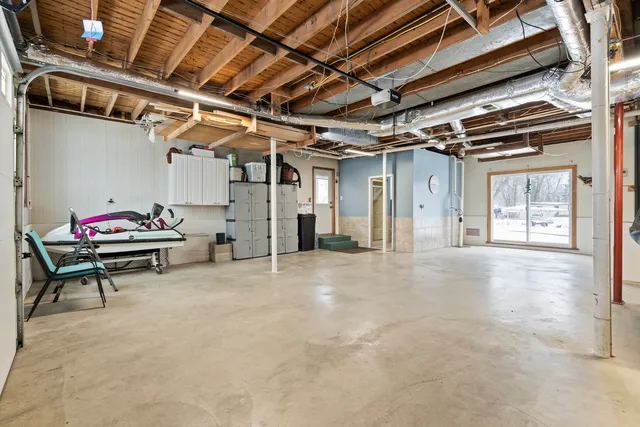a bed sitting in a room next to a window