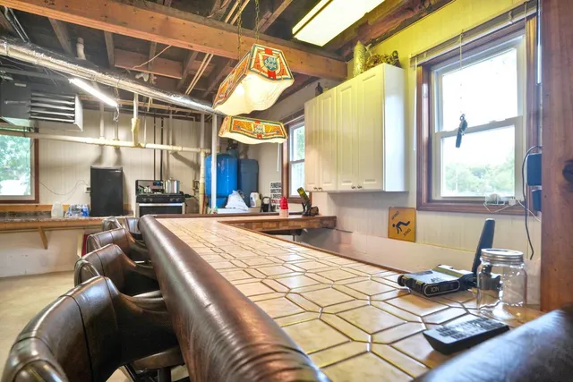 a living room with patio furniture and a chandelier