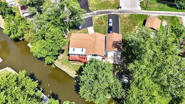 an aerial view of residential house with outdoor space and lake view