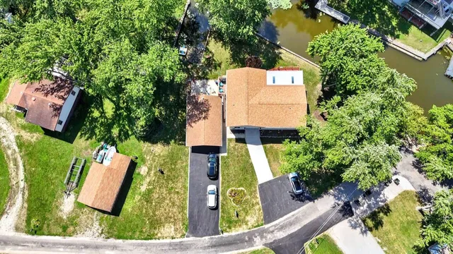 an aerial view of a house with swimming pool and garden