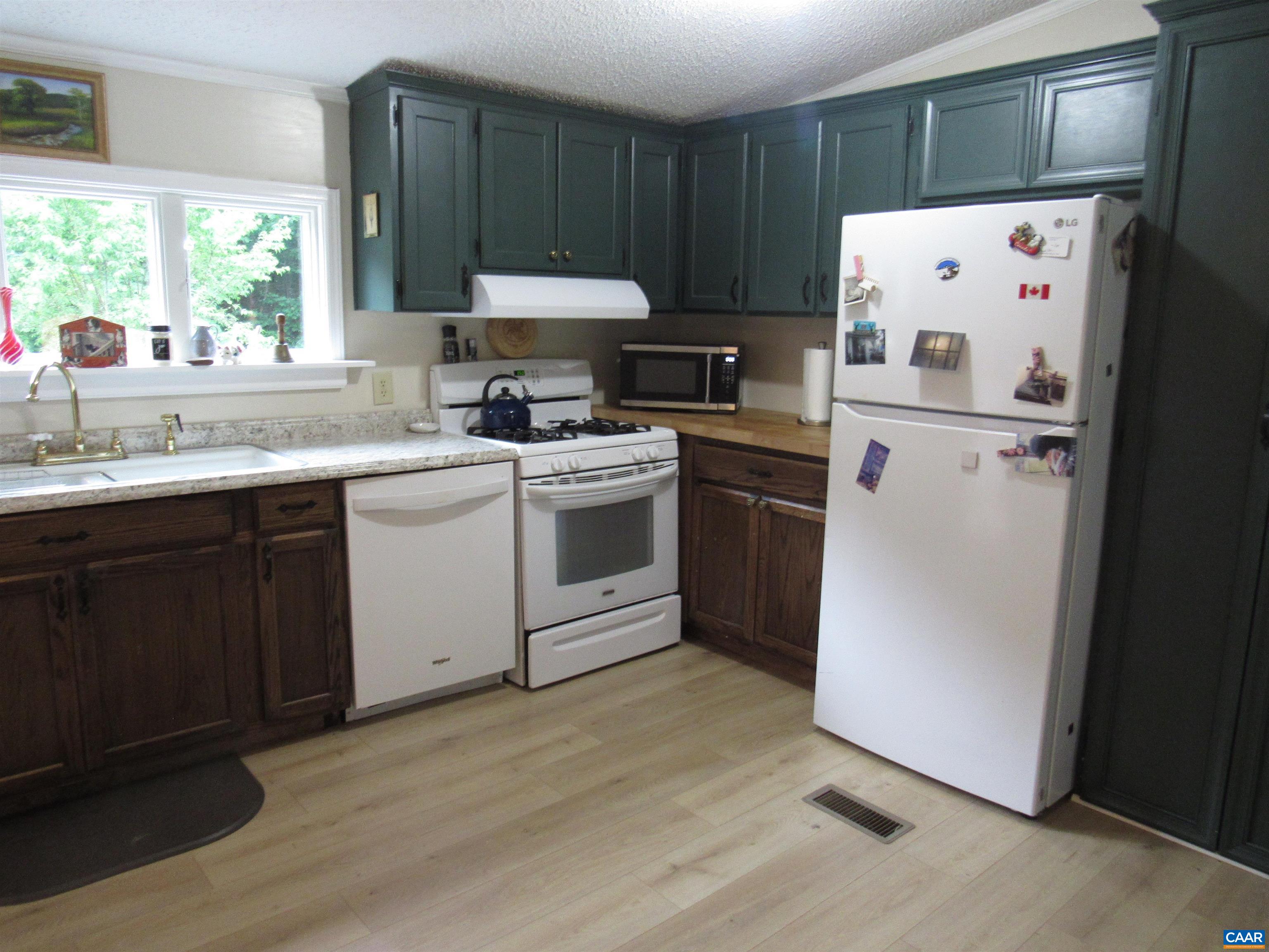 1992 Jerusalem Church Road Buckingham, VA 23921 - Photo 25 of 33 a kitchen with a white stove top oven and refrigerator