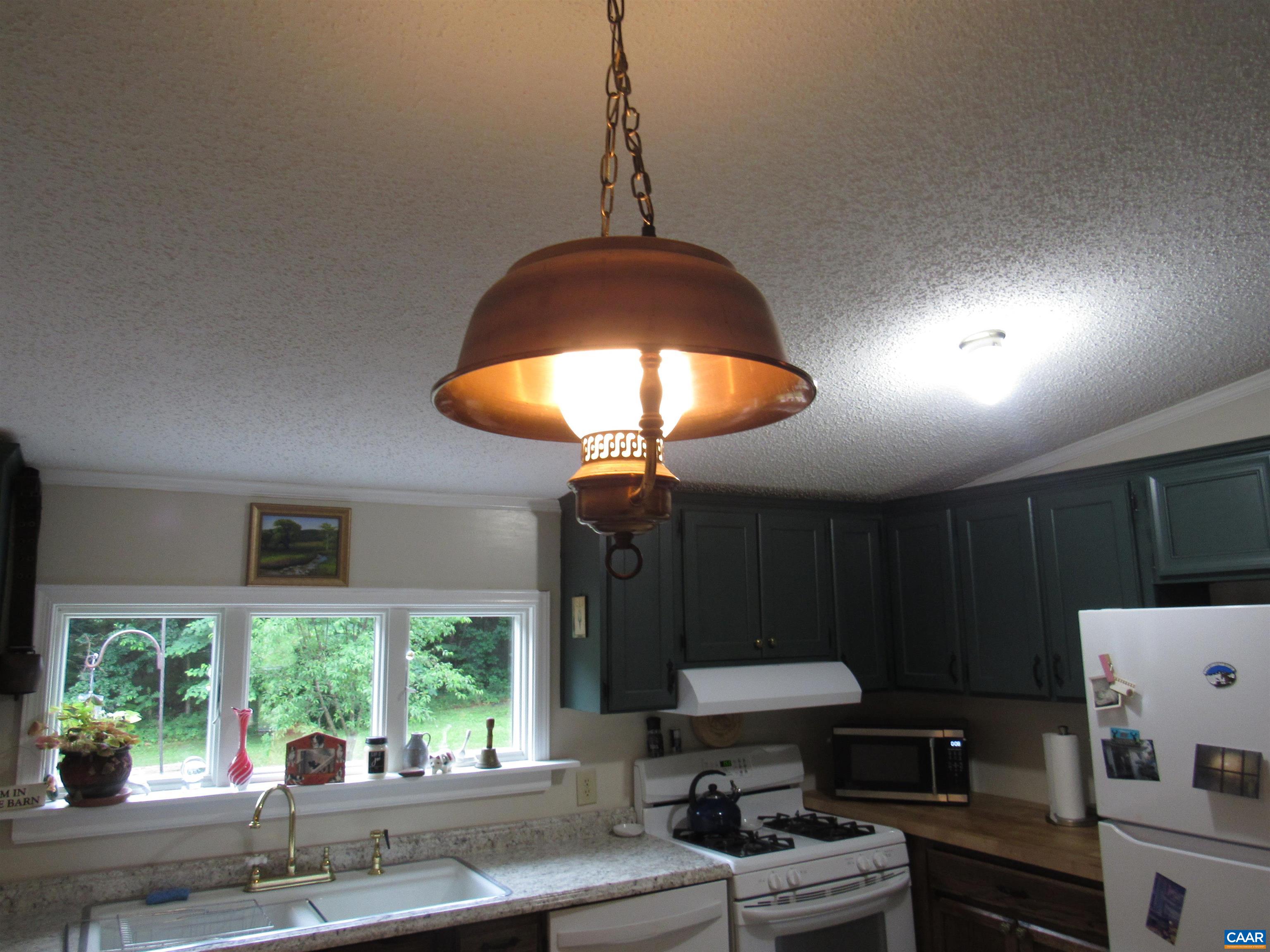 1992 Jerusalem Church Road Buckingham, VA 23921 - Photo 26 of 33 a kitchen with stainless steel appliances granite countertop a stove a sink dishwasher and a microwave with potted plants
