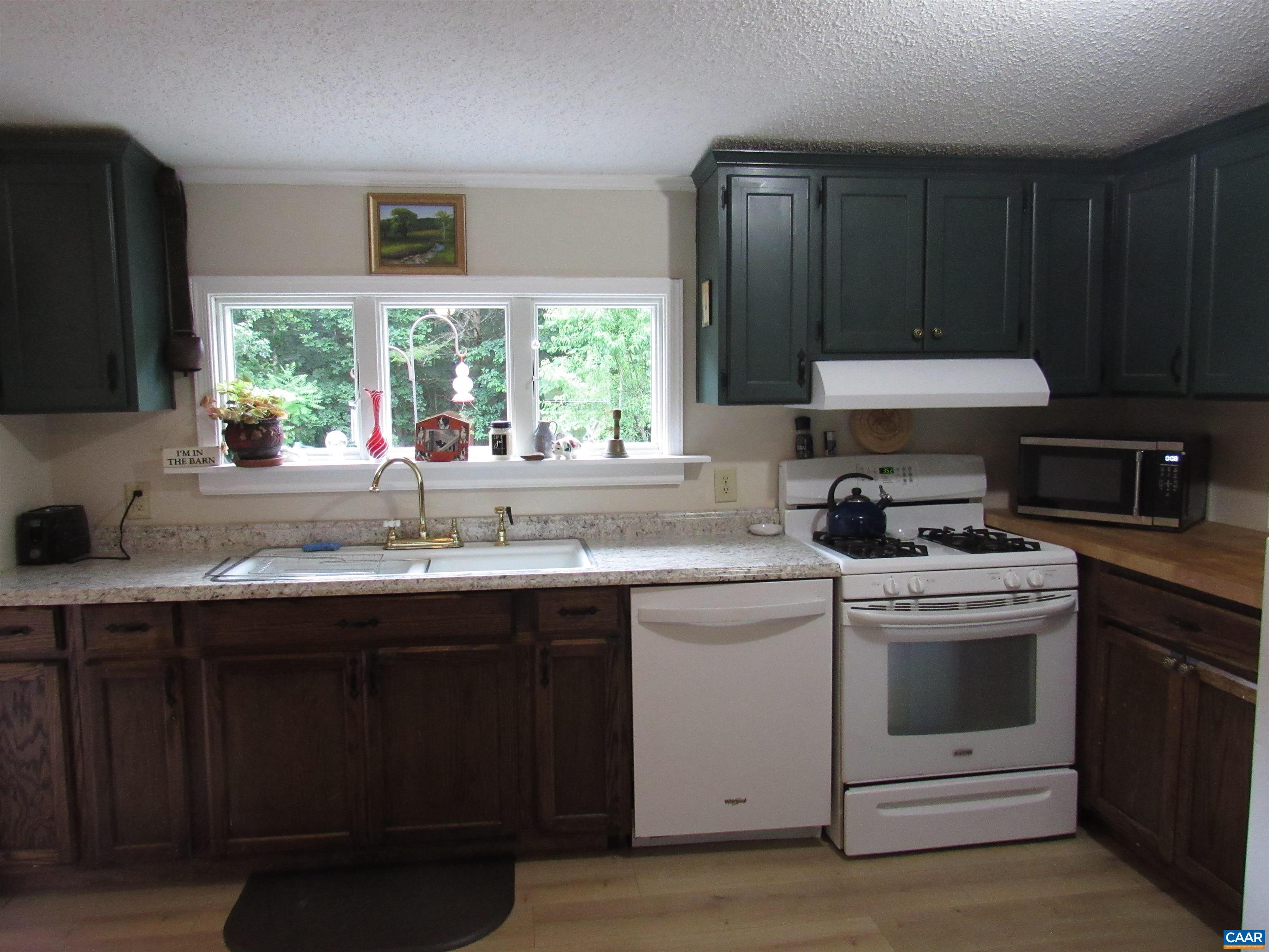 1992 Jerusalem Church Road Buckingham, VA 23921 - Photo 27 of 33 a kitchen with a sink stove top oven and cabinets