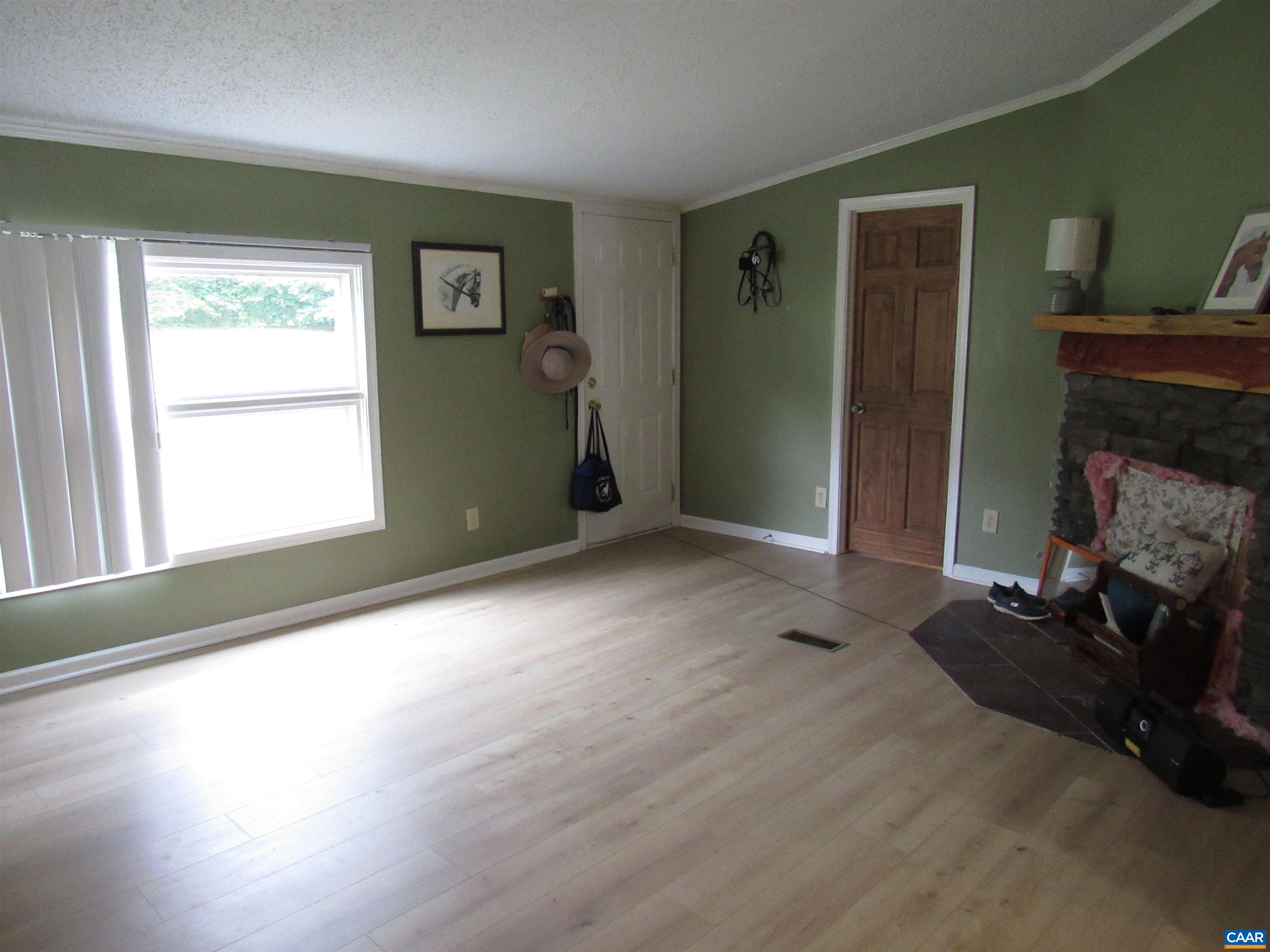 1992 Jerusalem Church Road Buckingham, VA 23921 - Photo 10 of 33 a view of empty room with wooden floor and fan