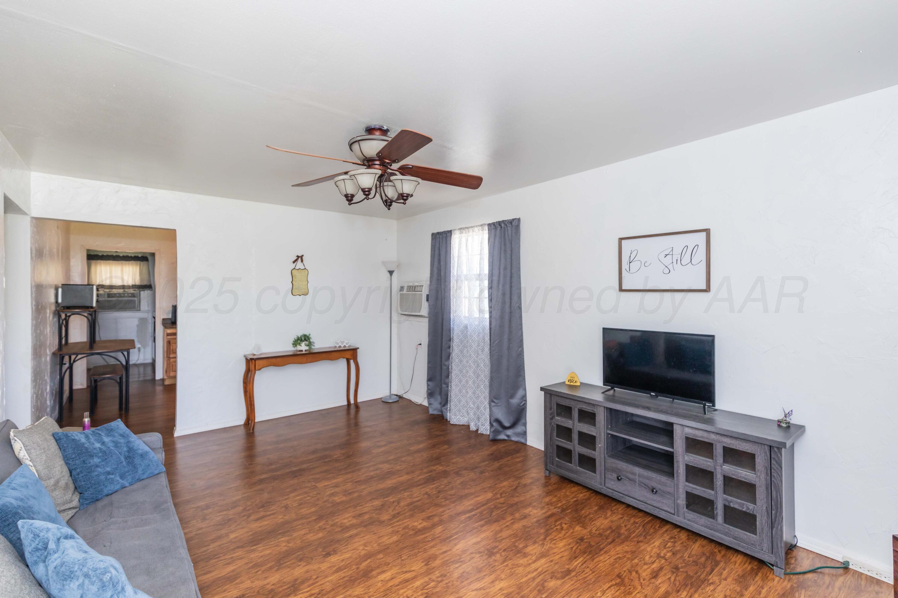 105 Poplar Street Skellytown, TX 79080 - Photo 11 of 37 a living room with furniture and a flat screen tv