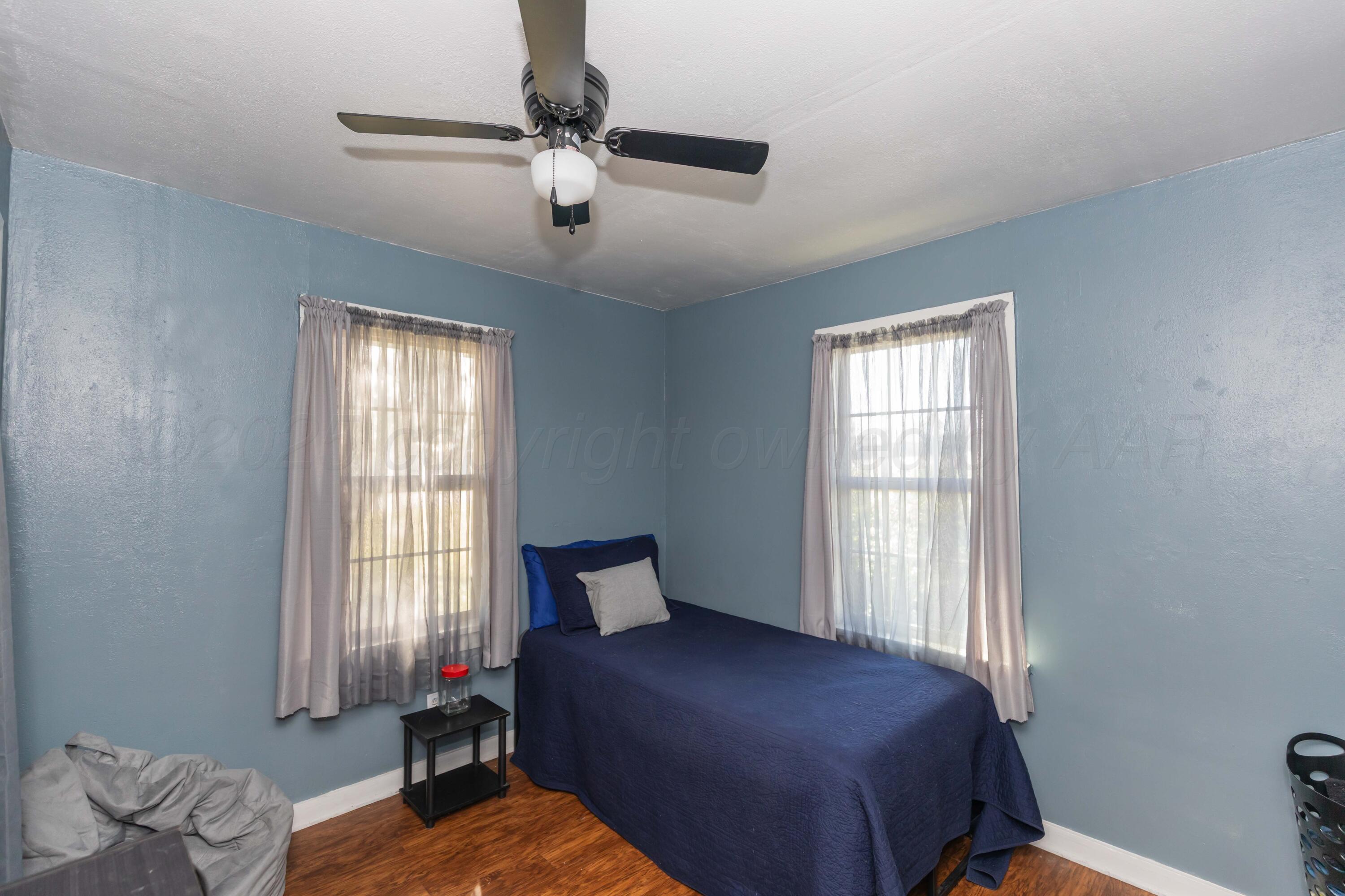 105 Poplar Street Skellytown, TX 79080 - Photo 30 of 37 a bedroom with a bed and window