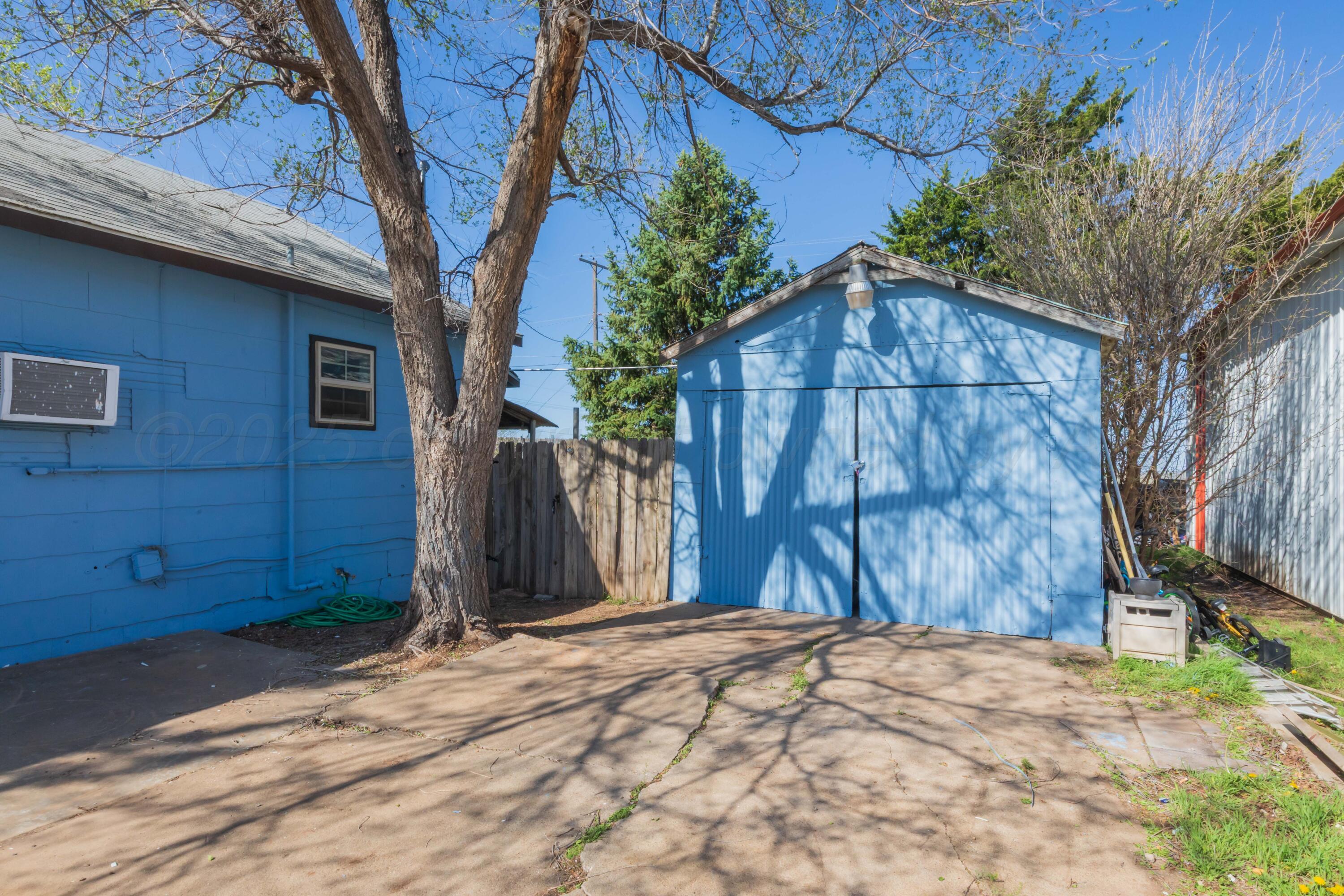 105 Poplar Street Skellytown, TX 79080 - Photo 37 of 37 a wooden fence under a large tree