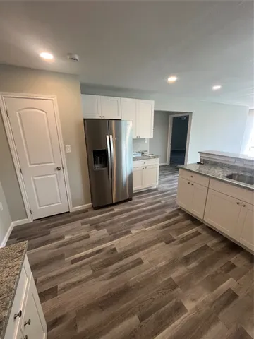 a kitchen with stainless steel appliances a refrigerator and a stove top oven