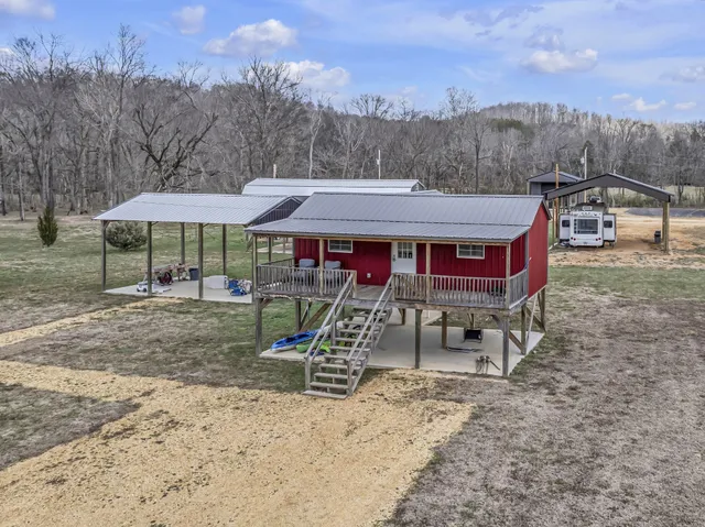 a view of a wooden dinning table with chairs in patio