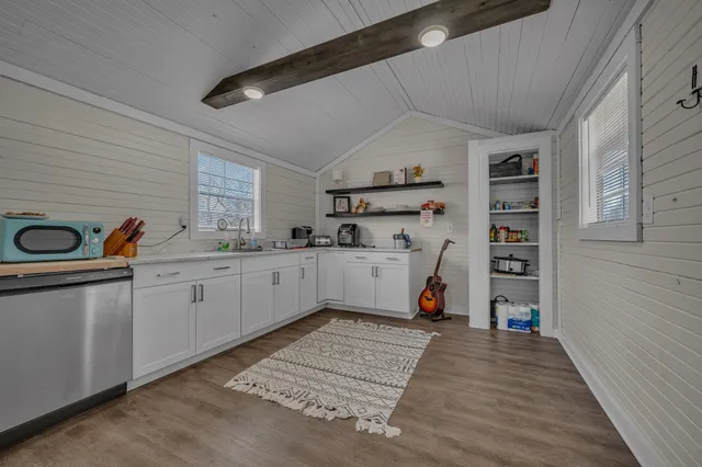a view of kitchen with cabinets and wooden floor