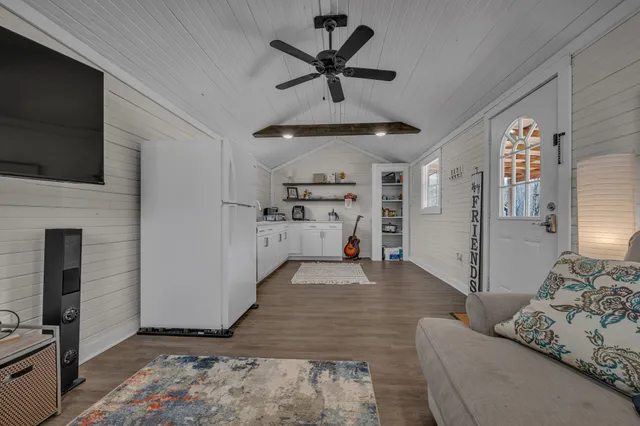 a view of a livingroom with furniture and a flat screen tv