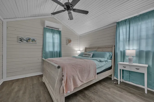 a bedroom with a bed and a ceiling fan