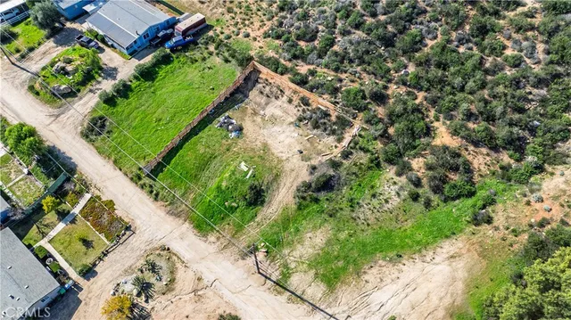 an aerial view of a house with a yard and lake view in back