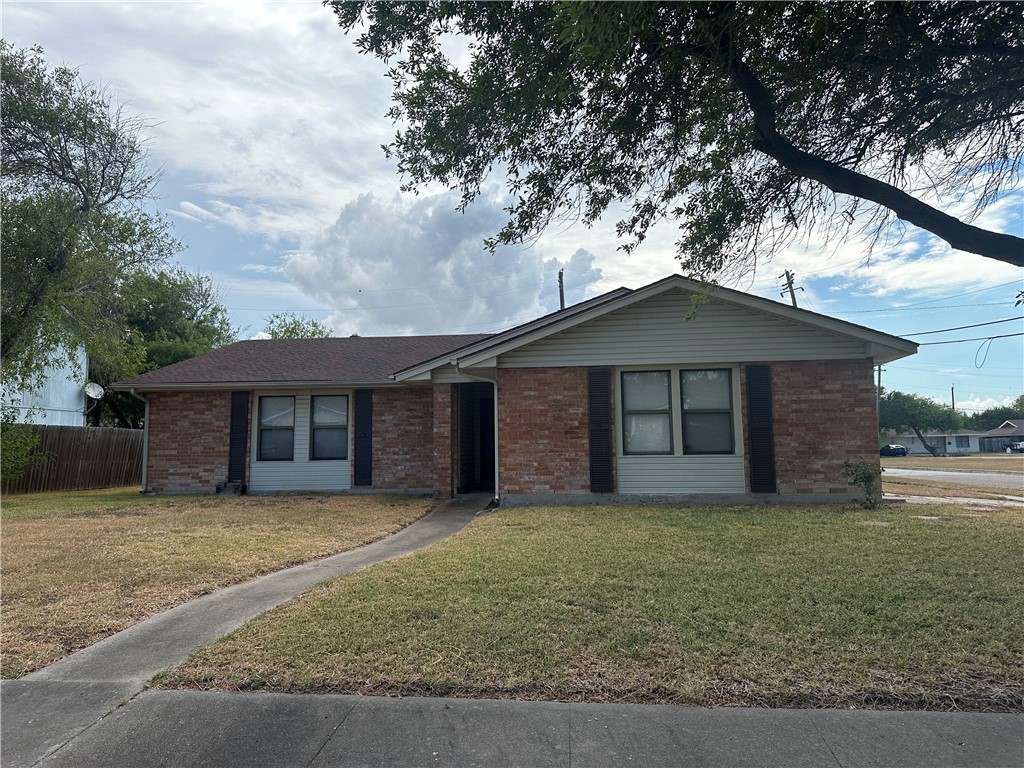 1502 Cheyenne Street Portland, TX 78374 - Photo 1 of 10 a front view of a house with yard and trees
