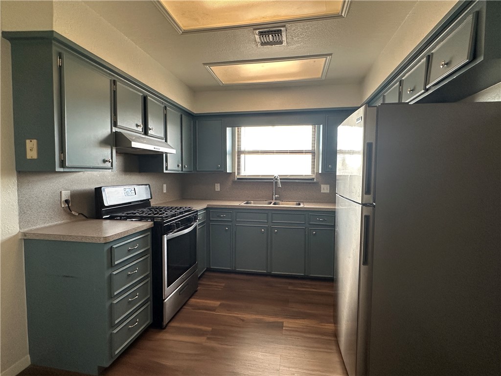 1502 Cheyenne Street Portland, TX 78374 - Photo 2 of 10 a kitchen with stainless steel appliances granite countertop a sink stove and refrigerator