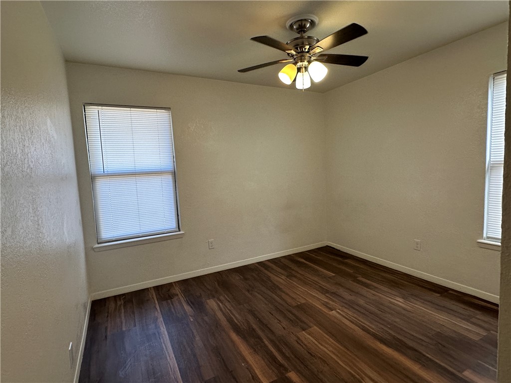 1502 Cheyenne Street Portland, TX 78374 - Photo 7 of 10 an empty room with a window and wooden floor