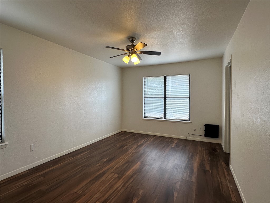 1502 Cheyenne Street Portland, TX 78374 - Photo 8 of 10 a view of an empty room with window and wooden floor