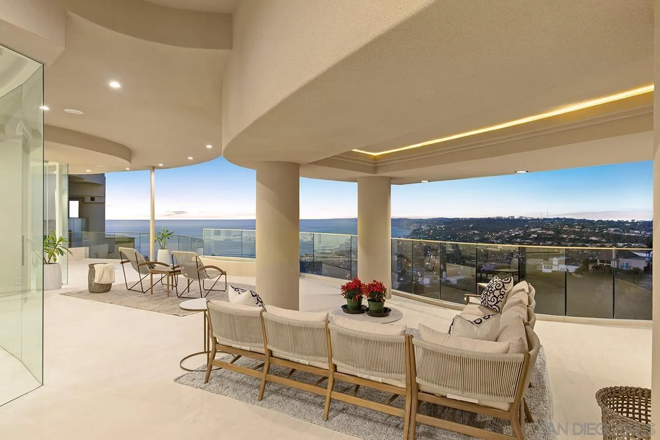 7447 Hillside Drive La Jolla, CA 92037 - Photo 15 of 55 a living room with furniture a rug and a floor to ceiling window