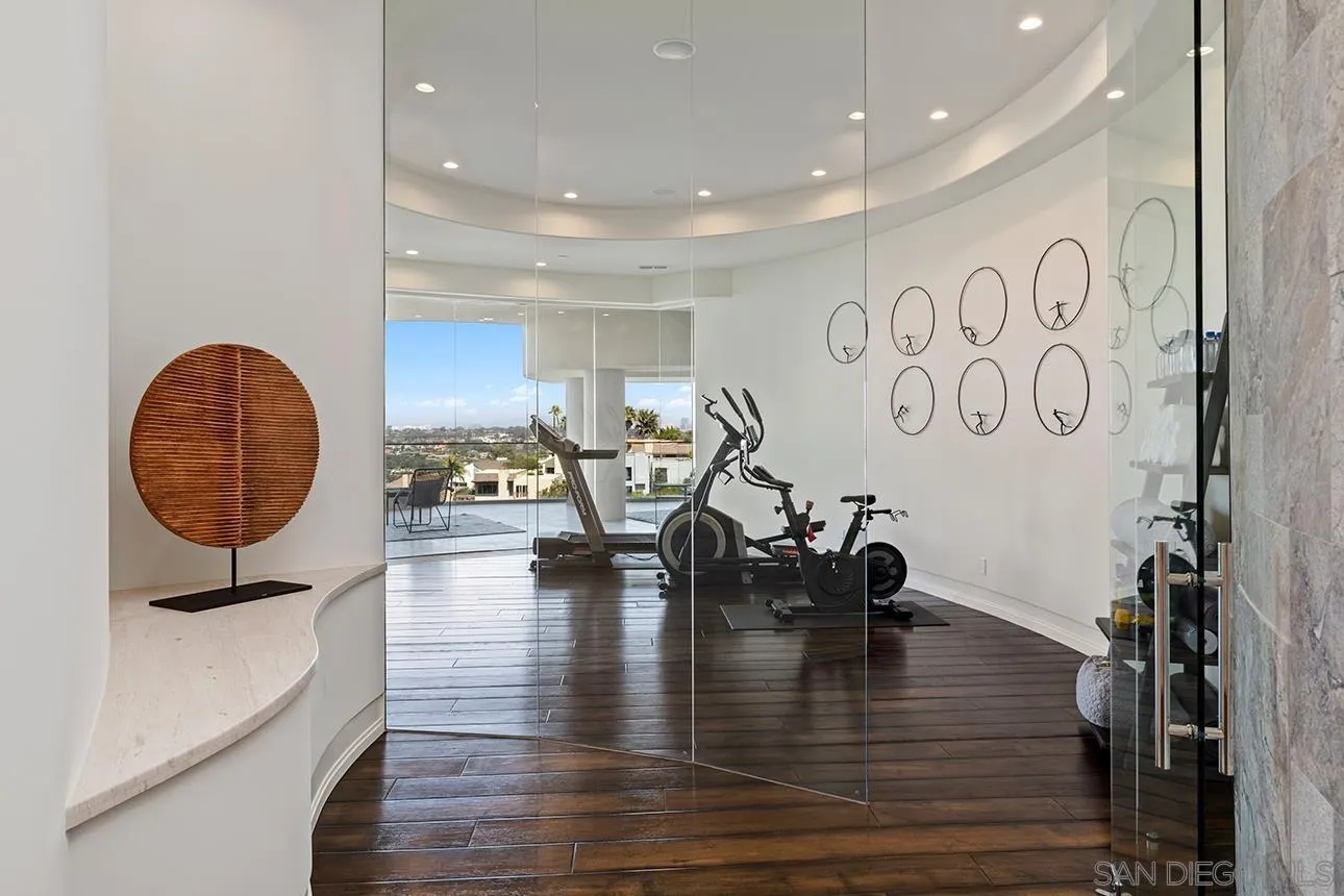 7447 Hillside Drive La Jolla, CA 92037 - Photo 28 of 55 a view of a room with gym equipment and floor to ceiling window