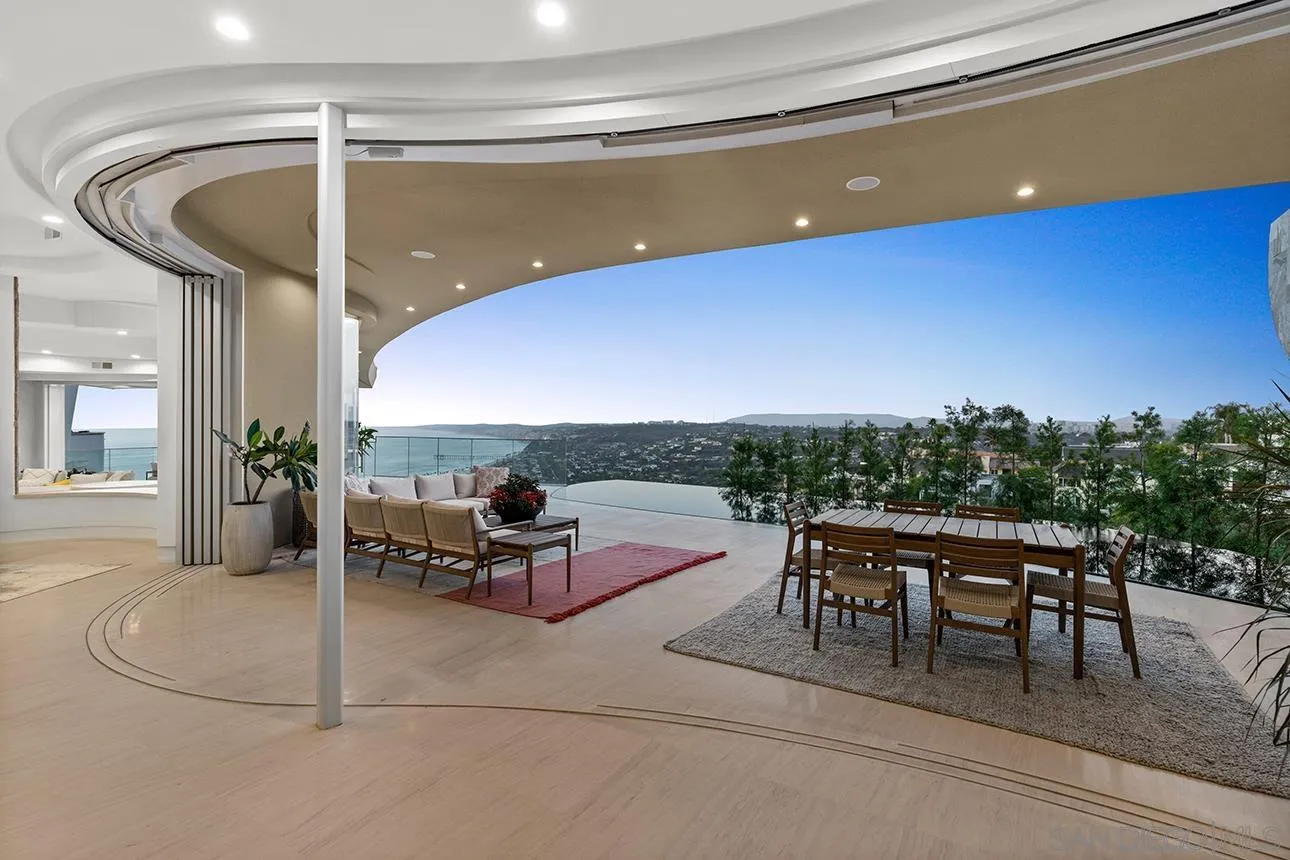 7447 Hillside Drive La Jolla, CA 92037 - Photo 34 of 55 a dining room with furniture and a floor to ceiling window