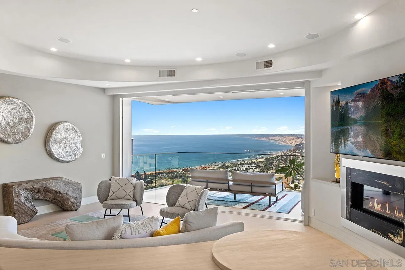 7447 Hillside Drive La Jolla, CA 92037 - Photo 39 of 55 a living room with fireplace furniture and a flat screen tv
