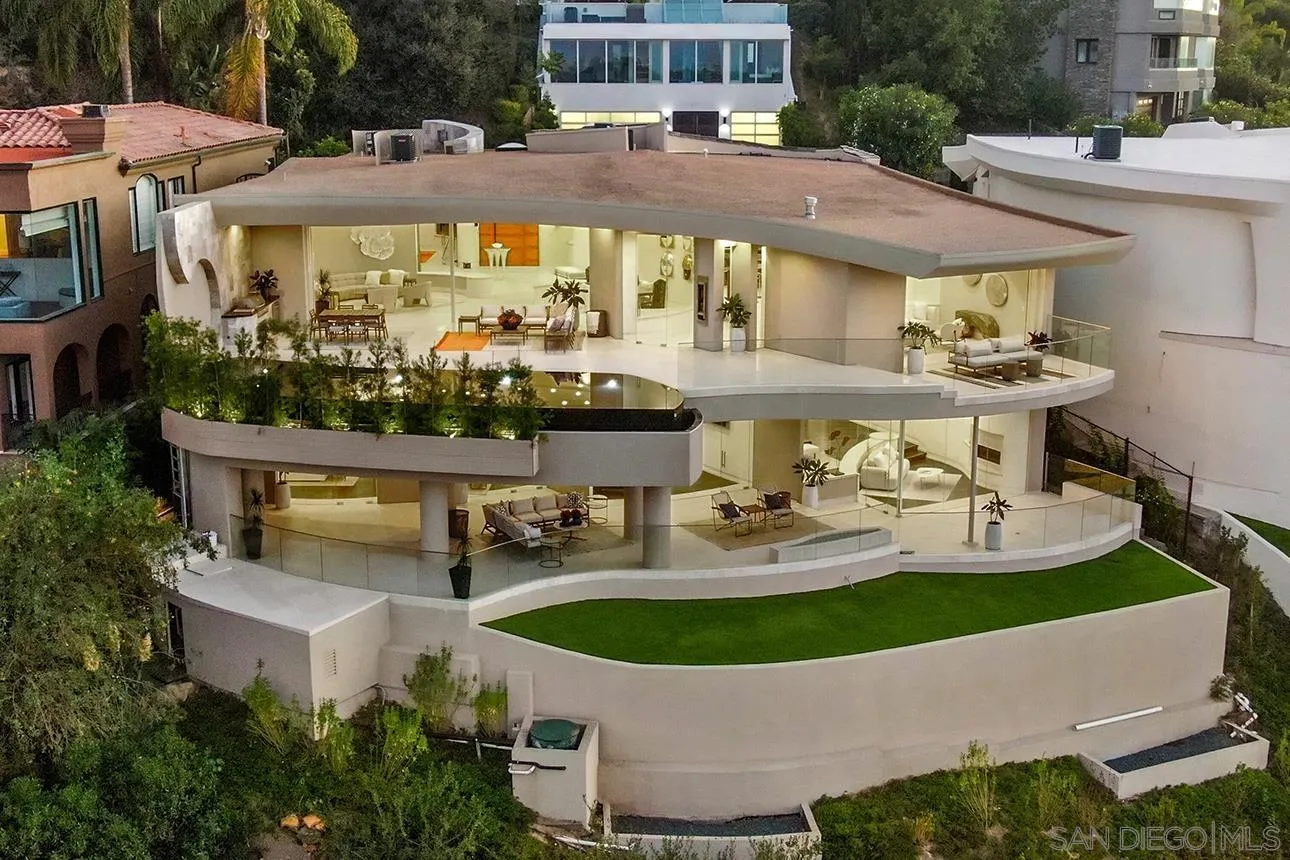 7447 Hillside Drive La Jolla, CA 92037 - Photo 5 of 55 a view of a patio with table and chairs potted plants and large trees