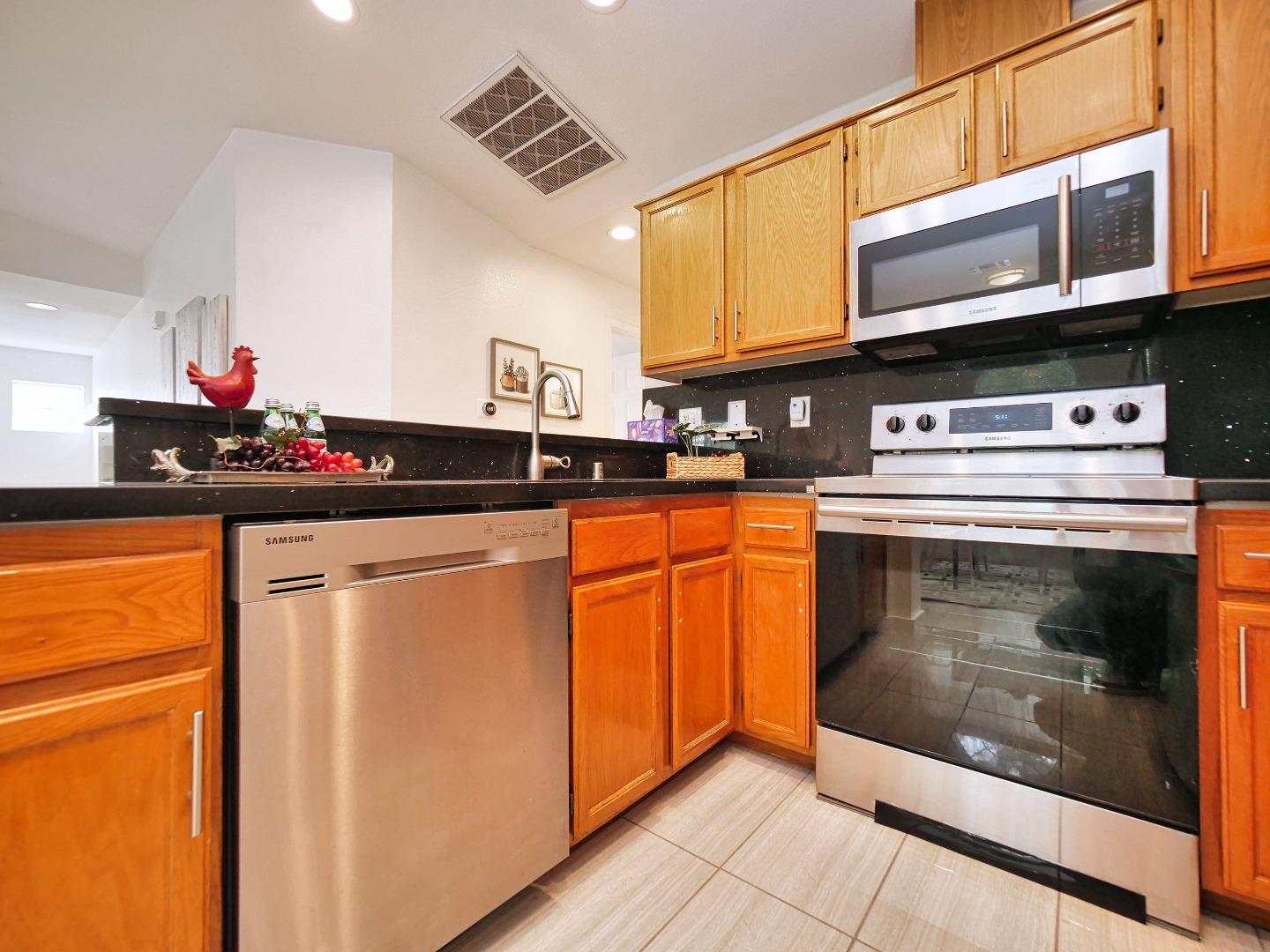 1302 Dawn Court San Ramon, CA 94583 - Photo 57 of 100 a kitchen with stainless steel appliances granite countertop a stove and a microwave