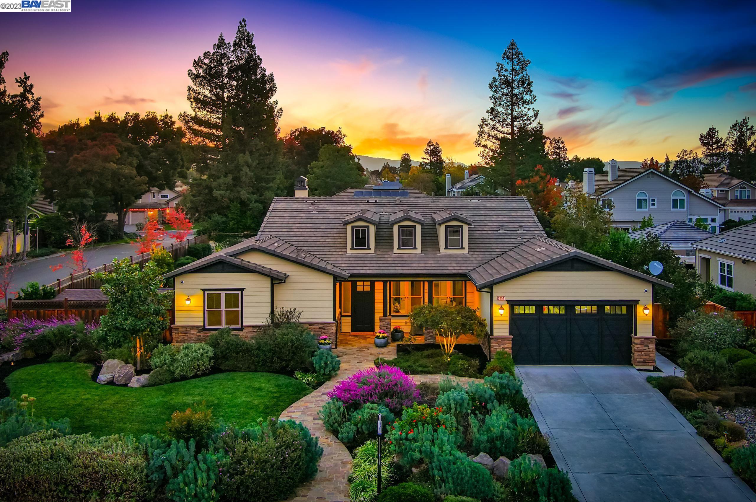 a front view of a house with garden