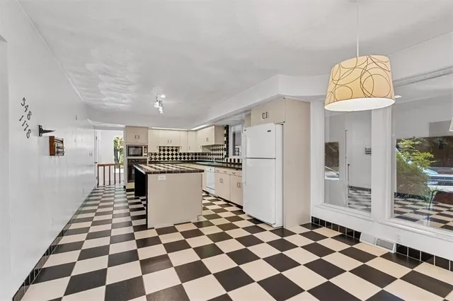 a kitchen with a checkered floor and a black white checkered floor