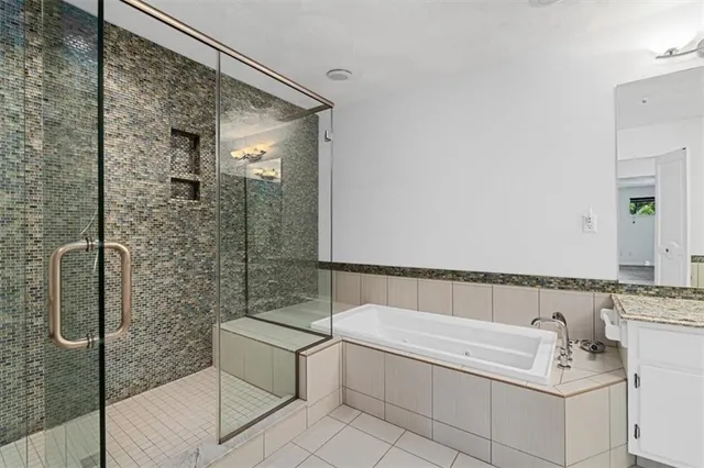 a bathroom with a bathtub and shower