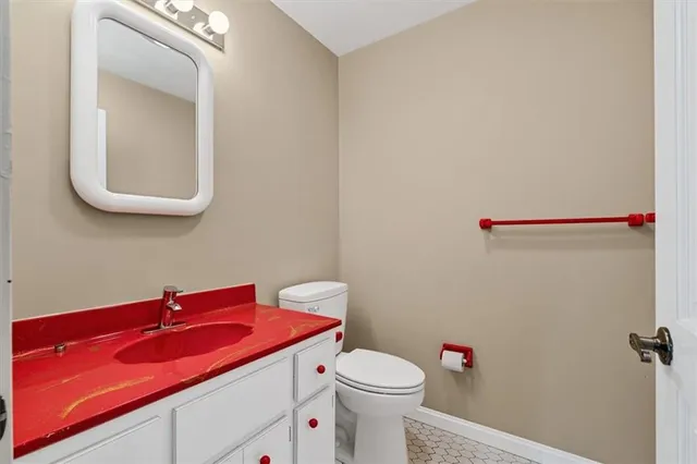 a bathroom with a sink a toilet and mirror