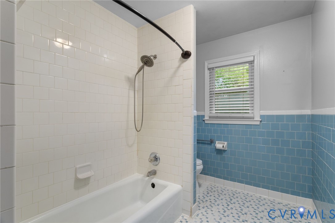 8141 Military Road Amelia Court House, VA 23002 - Photo 19 of 40 a bathroom with a bathtub a shower and a window
