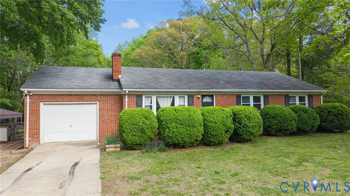 8141 Military Road Amelia Court House, VA 23002 - Photo 2 of 40 a front view of a house with a garden
