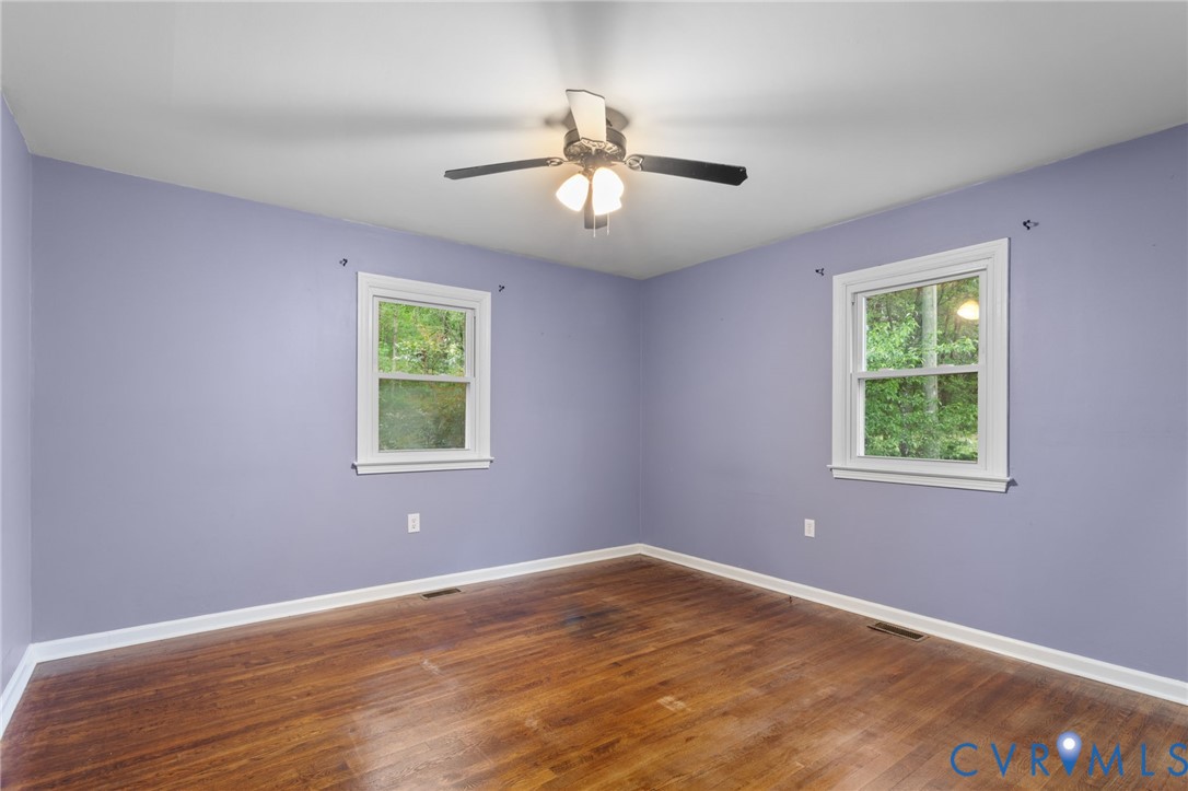 8141 Military Road Amelia Court House, VA 23002 - Photo 26 of 40 a view of an empty room with wooden floor and a window