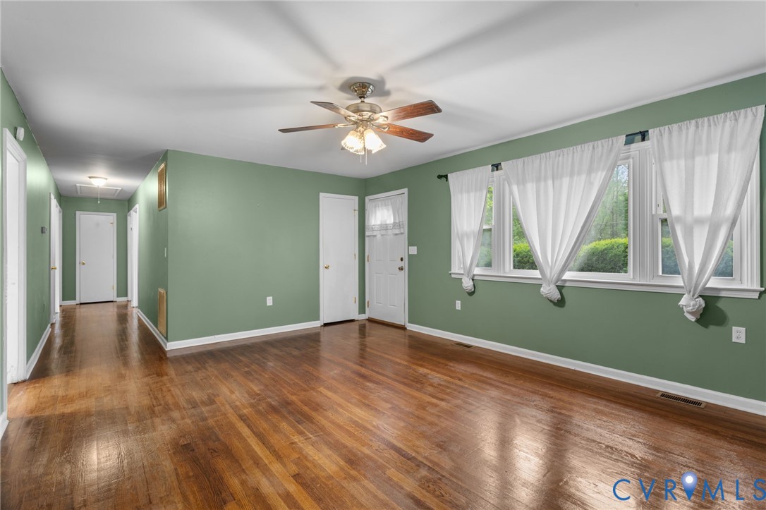 8141 Military Road Amelia Court House, VA 23002 - Photo 10 of 40 a view of an empty room with window and chandelier fan