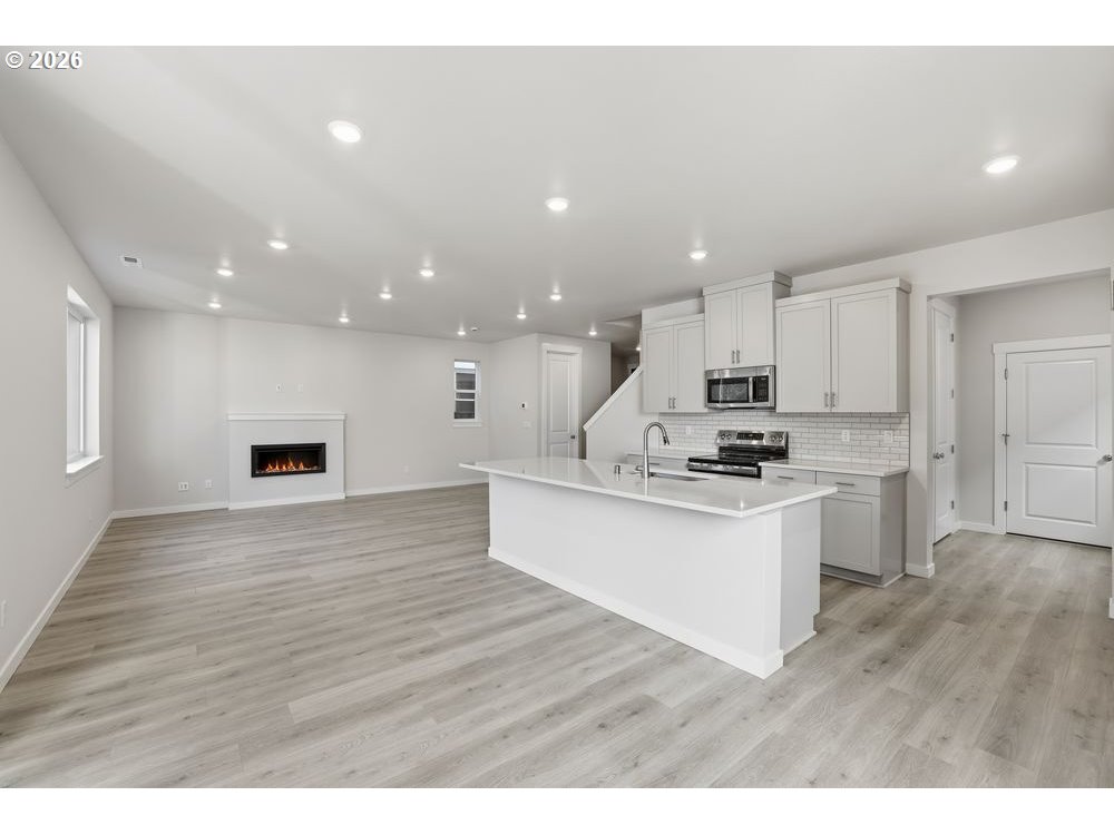 3115 Southwest 4th Avenue Battle Ground, WA 98604 - Photo 14 of 20 a kitchen with stainless steel appliances kitchen island granite countertop a stove a sink and a refrigerator